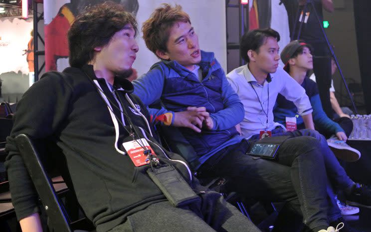 Masato 'Bonchan' Takahashi (middle) speaks with Daigo Umehara (left) 