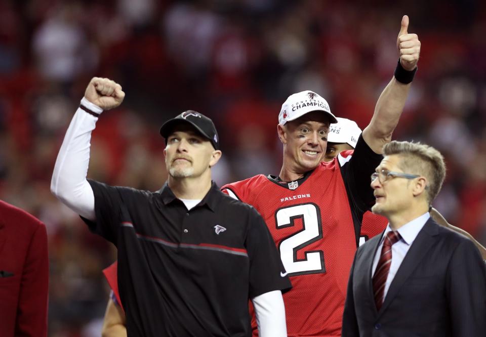 Matt Ryan #2 and head coach Dan Quinn of the Atlanta Falcons celebrate after defeating the Green Bay Packers in the NFC Championship Game at the Georgia Dome on January 22, 2017 in Atlanta, Georgia. The Falcons defeated the Packers 44-21. (Photo by Rob Carr/Getty Images)