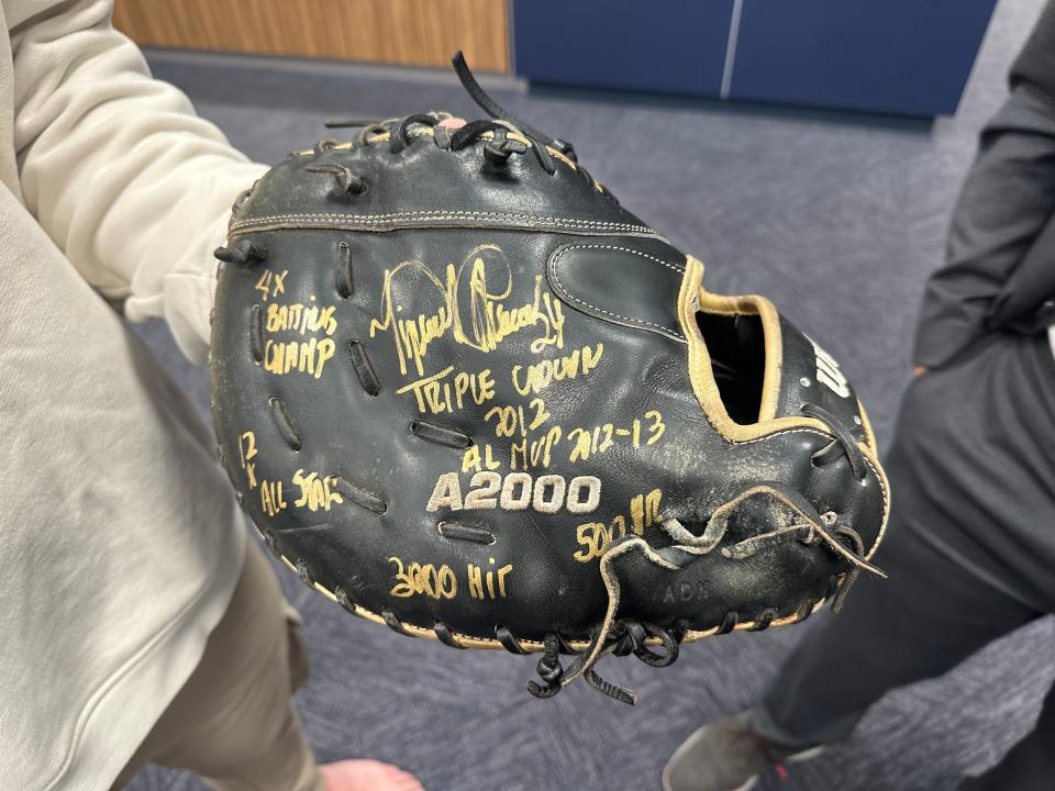Spencer Torkelson holds his first baseman's glove, signed by Miguel Cabrera, in the Detroit Tigers' clubhouse after Cabrera's final game Sunday, Oct. 1, 2023, at Comerica Park.
