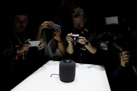 Members of the media photograph a prototype Apple HomePod during the annual Apple Worldwide Developer Conference (WWDC) in San Jose, California, U.S. June 5, 2017. REUTERS/Stephen Lam