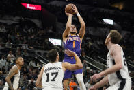 Phoenix Suns guard Devin Booker (1) shoots against the San Antonio Spurs during the second half of an NBA basketball game, Monday, Jan. 17, 2022, in San Antonio. (AP Photo/Eric Gay)