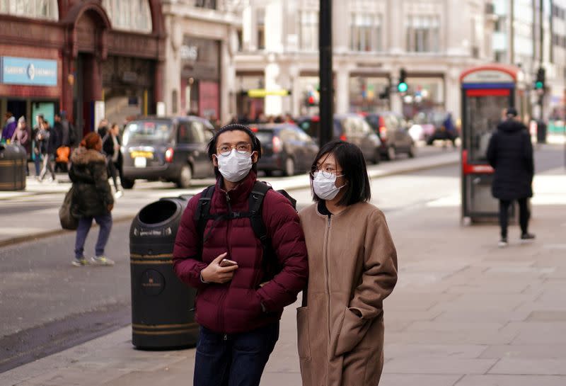 People wear protective face masks in central London