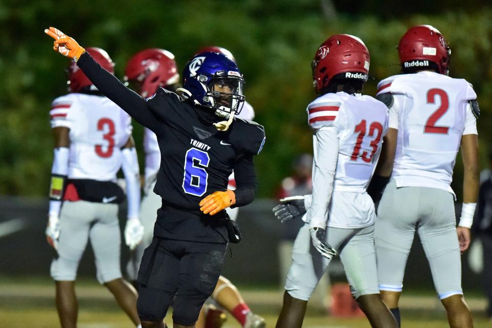 Trinity Christian's Darias James (6) signals a first down pick up during the first quarter Friday.