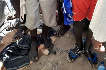 People with chained legs are pictured after being rescued by police in Sabon Garin