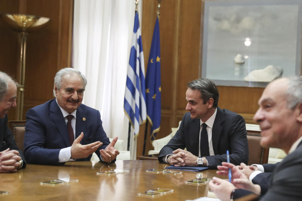 Greek Prime Minister Kyriakos Mitsotakis, second right, meets with Libyan Gen. Khalifa Hifter, second left, in Athens, Friday, Jan. 17, 2020. The commander of anti-government forces in war-torn Libya has begun meetings in Athens in a bid to counter Turkey's support for his opponents. (AP Photo/Petros Giannakouris)