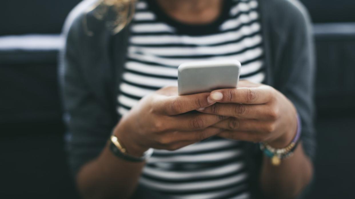 Woman's hands holding smartphone