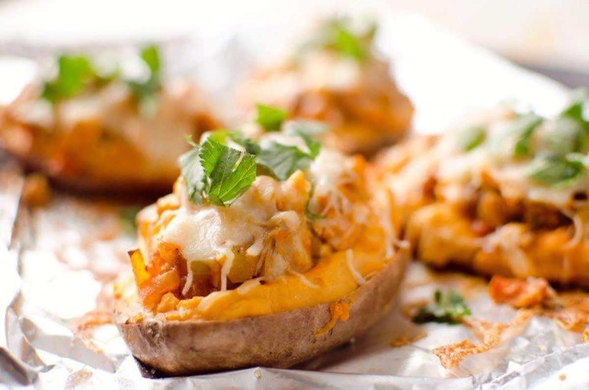 <p>The Creative Bite</p><p>Fluffy baked sweet potato halves loaded with topped with buffalo chicken, veggies and reduced fat cheese for a complete meal loaded with bold flavor.</p><p><strong>Get the recipe:<a href="http://www.thecreativebite.com/twice-baked-buffalo-chicken-sweet-potatoes/2/" rel="nofollow noopener" target="_blank" data-ylk="slk:Twice-Baked Buffalo Chicken Sweet Potatoes;elm:context_link;itc:0;sec:content-canvas" class="link rapid-noclick-resp">Twice-Baked Buffalo Chicken Sweet Potatoes</a></strong></p>