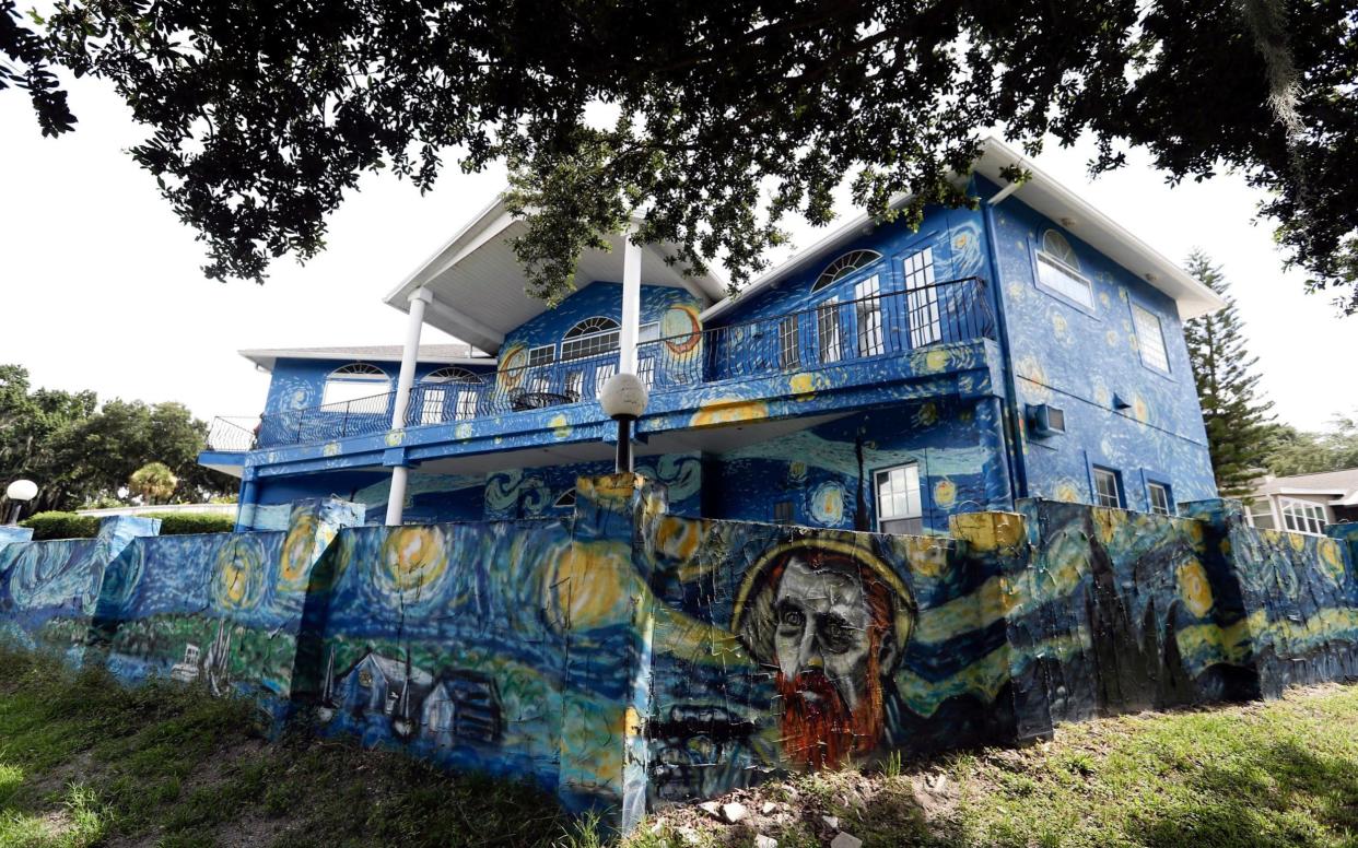 The couple can keep the mural and the city must pay them $15,000 and remove a property lien - AP