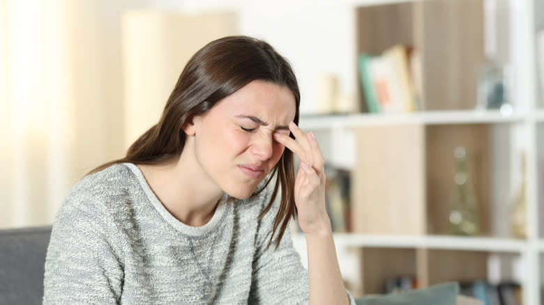 woman scratching her eye