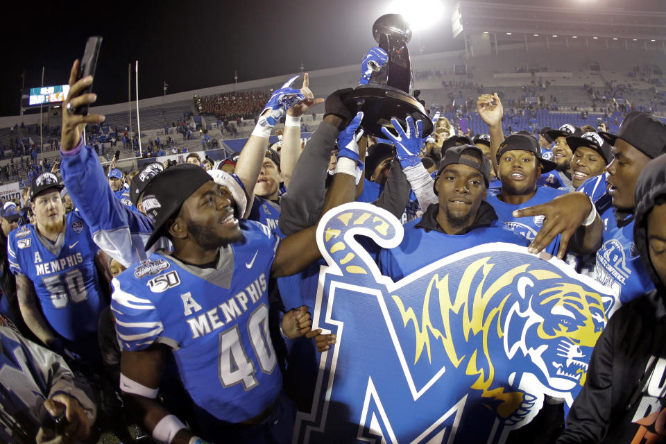 Memphis players celebrate after defeating Cincinnati in an NCAA college football game for the American Athletic Conference championship Saturday, Dec. 7, 2019, in Memphis, Tenn. (AP Photo/Mark Humphrey)