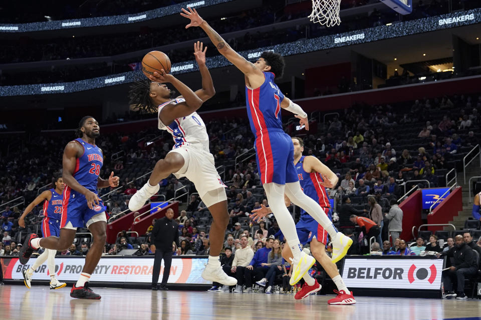 Philadelphia 76ers guard Tyrese Maxey (0) attempts a shot as Detroit Pistons guard Killian Hayes (7) defends during the first half of an NBA basketball game, Sunday, Jan. 8, 2023, in Detroit. (AP Photo/Carlos Osorio)