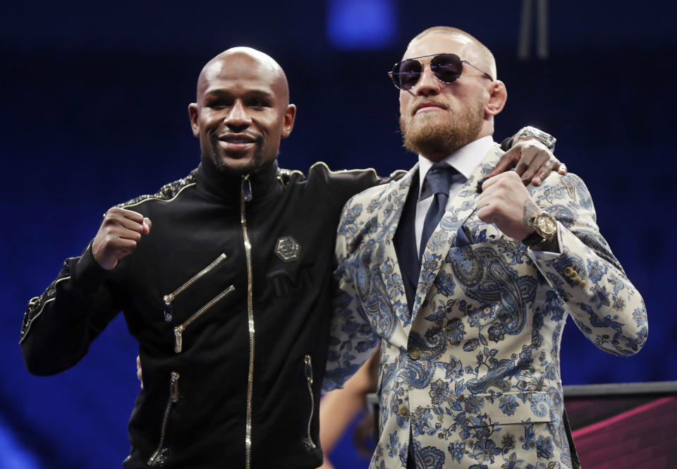 Floyd Mayweather Jr., left, and Conor McGregor pose during a news conference after a super welterweight boxing match Sunday, Aug. 27, 2017, in Las Vegas. (AP Photo/Isaac Brekken)