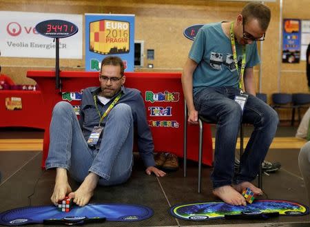 Competitors solve Rubik's cubes using their feet during the Rubik's Cube European Championship in Prague, Czech Republic, July 15, 2016. Picture taken July 15, 2016. REUTERS/David W Cerny