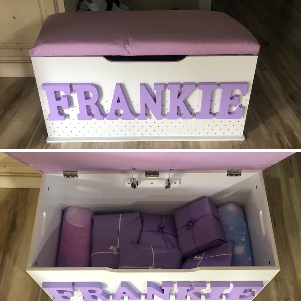 A Kmart toy box with a purple bench cushion and the name 'Frankie' in wooden letters on the front