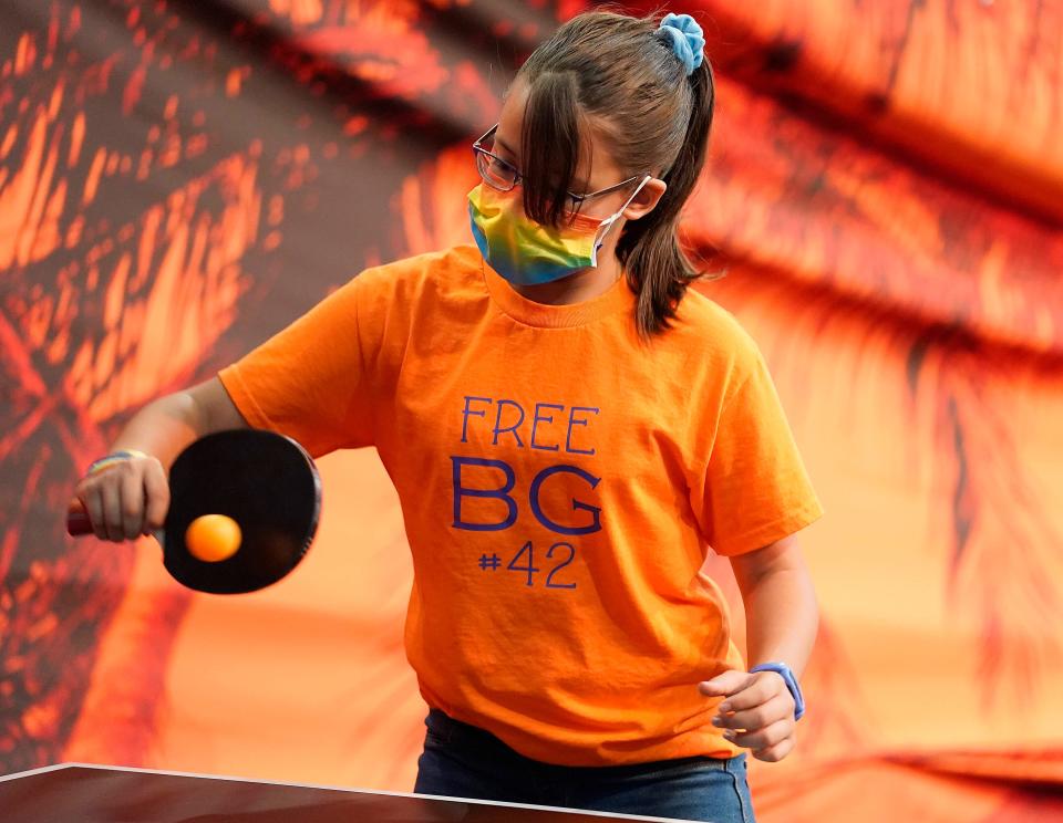 Phoenix Mercury fan Callie Fenderson-Gonzales wears a "Free BG #42" T-shirt referring to Brittney Griner before a WNBA basketball game between the Mercury and the Las Vegas Aces, Friday, May 6, 2022, in Phoenix.