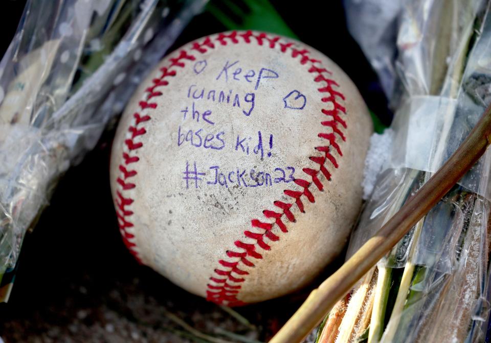 A baseball with 8-year-old Jackson Sparks' name, who was one of six victims killed in the parade, holds a message saying "Keep running the bases kid!" It'ss among the items left at Veterans Park as a memorial commemorating those who were killed in the Waukesha Christmas Parade tragedy that left six people dead and more than 60 injured.