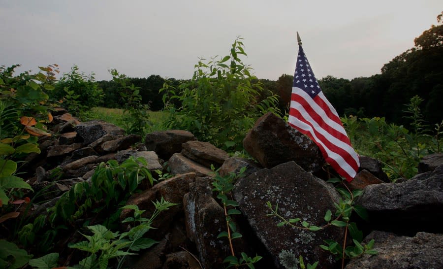 GETTYSBURG, PA – JULY 03: An American flag sits on a stone wall near Devil’s Den at the Gettysburg battlefield July 3, 2005, in Gettysburg, Pennsylvania. It is the site of the largest battle ever waged during the American Civil War. Fought in the first three days of July 1863, the Battle of Gettysburg resulted in a hallmark victory for the Union and ended the second invasion of the North by General Robert E. Lee’s army. Gettysburg marks the beginning of the “Journey Through Hallowed Ground” Corridor, which encompasses a 175-mile-long stretch of land from Gettysburg, PA to Monticello, VA, and has been recognized by national historians as the region that holds more American history than any other place in the country. The land is imminently threatened by suburban sprawl, according to the recently released study by the National Trust for Historic Preservation in its annual list of America’s most endangered historic places. (Photo by Joe Raedle/Getty Images)