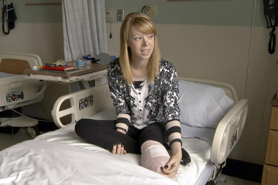 FILE — Adrianne Haslet sits on her bed at Spaulding Rehabilitation Hospital, in Boston, April 24, 2013. Haslet, a ballroom dancer, lost part of her left leg when bombs exploded near the Boston Marathon finish line. Haslet is back in the field in 2023 for Monday's 127th Boston Marathon as the city, the country and fans of the cherished sporting event mark 10 years since the finish-line attacks. (AP Photo/Ted Shaffrey, File)