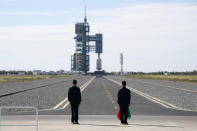 Officials stand on the tarmac ahead of the liftoff at the Jiuquan Satellite Launch Center in Jiuquan in northwestern China, Thursday, June 17, 2021. China has launched the first three-man crew to its new space station in its the ambitious programs first crewed mission in five years. (AP Photo/Ng Han Guan)