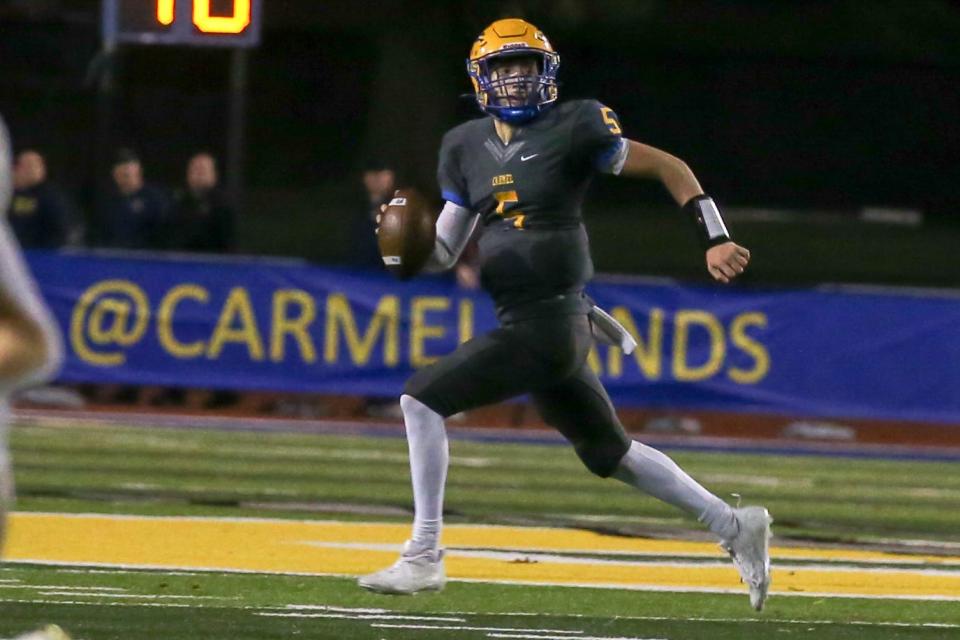 Carmel's Anthony Coellner (5) scrambles from the pocket looking for an open receiver as Carmal takes on Westfield in the IHSAA football Class 6A sectional, Oct 27, 2023; Carmel, IN, USA; at Carmel High School.