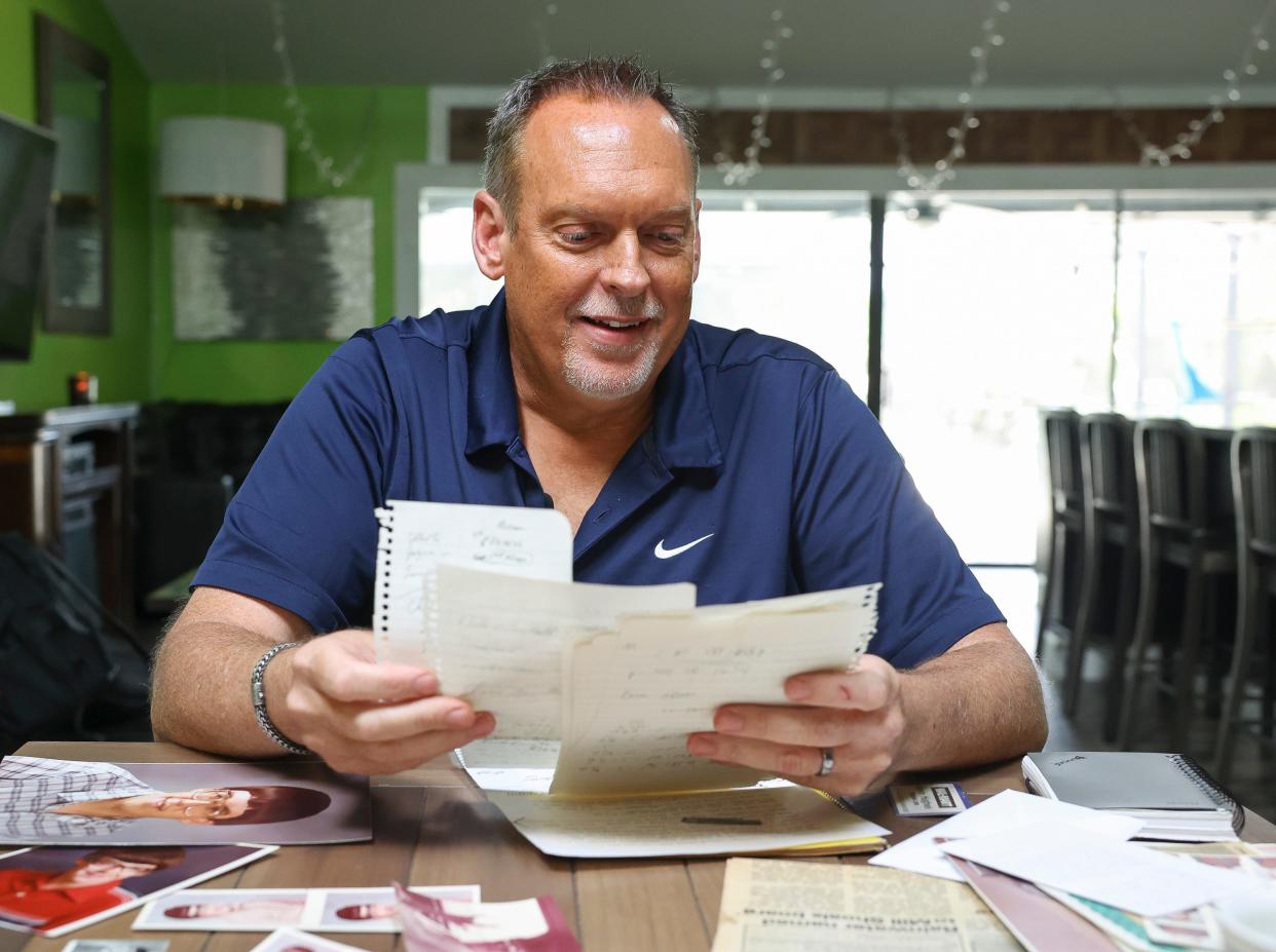 Kyle Hughes, brother of "Murder on Music Row" victim Kevin Hughes, looks through old letters and photos during an interview at his home, Friday, Aug. 25, 2023, in Palm City, Fla. Kevin, 23, the chart director for Cash Box magazine, was shot to death on March 9, 1989, after coming out of a recording studio.