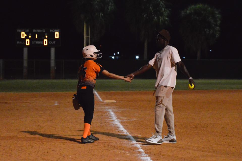 John I. Leonard's Arianna Sheerer shakes Jazz Chisholm's hand after he throws the first pitch on Feb. 12, 2024.