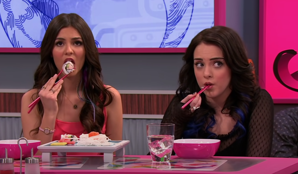 Tori Vega uses chopsticks to lift a piece of sushi to her mouth, and Jade West has her chopsticks in between her teeth