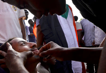 Sudanese demonstrator is shaven as he attends a protest rally demanding Sudanese President Omar Al-Bashir to step down, outside Defence Ministry in Khartoum, Sudan April 10, 2019. REUTERS/Stringer