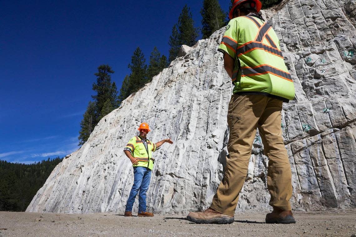 Vince Trimboli, an Idaho Transportation Department spokesperson, explains the process of cutting into rock with Alex Deduck, ITD project manager, during a tour of the mile-long stretch of Idaho Highway 55 north of Smiths Ferry.