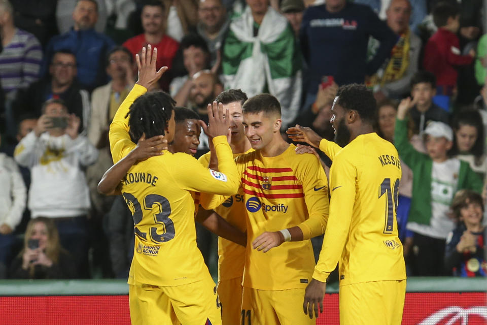 Barcelona's Ferran Torres celebrates with teammates after scoring his side's fourth goal during a Spanish La Liga soccer match between Elche and Barcelona, at the Martinez Valero Stadium in Elche, Spain, Saturday, April 1, 2023. (AP Photo/Alberto Saiz)