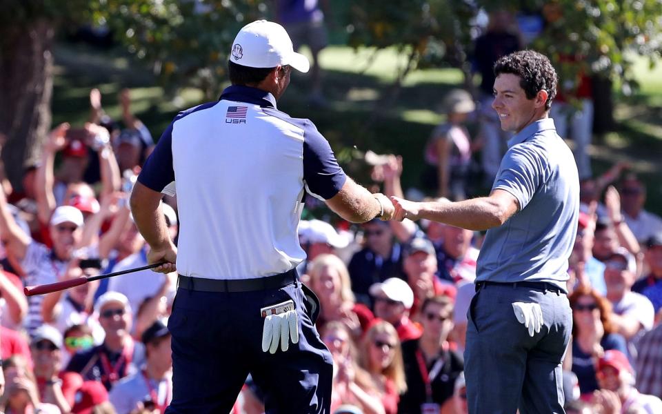 Patrick Reed of the United States and Rory McIlroy of Northern Ireland congratulate each other after making putts on the eighth green - USA TODAY