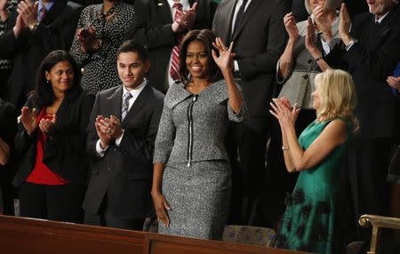 U.S. first lady Michelle Obama waves prior to her husband, U.S. President Barack Obama (Not pictured), delivered his State of the Union address to a joint session of Congress on Capitol Hill in Washington, January 20, 2015. REUTERS/Larry Downing