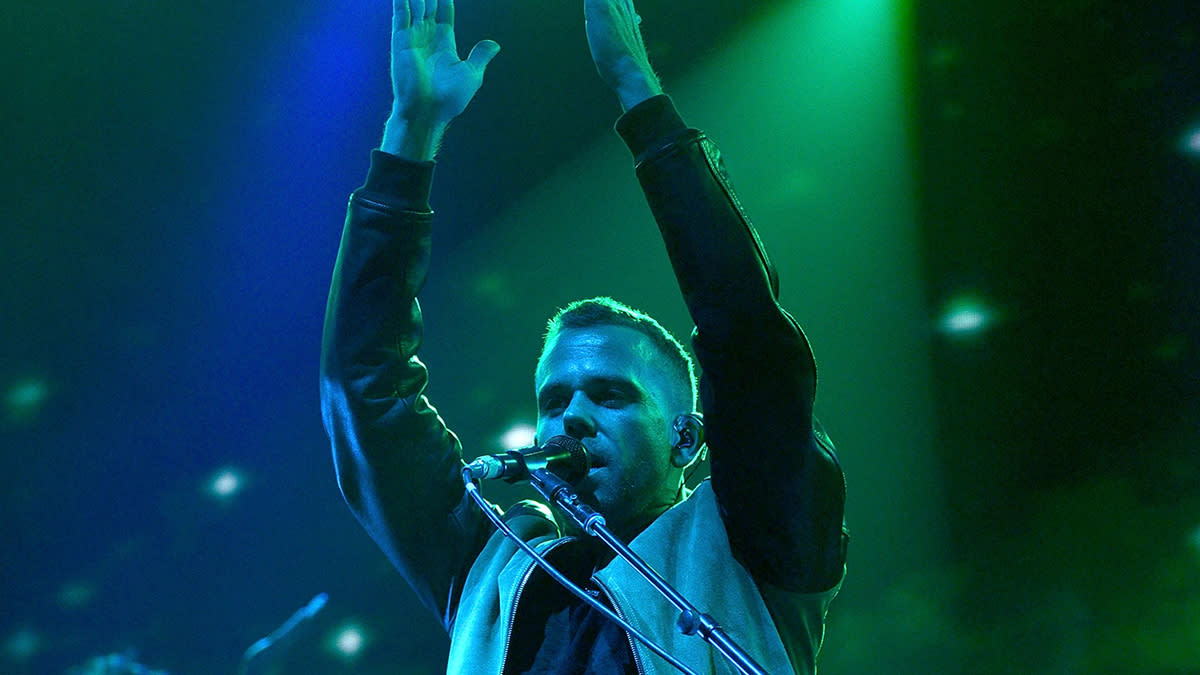  M83 on stage with hands in air 