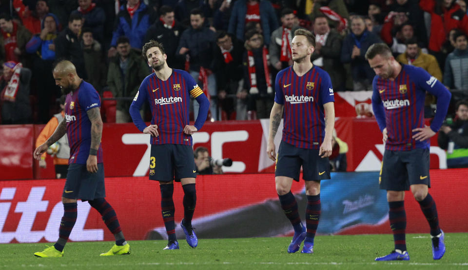 FC Barcelona's Gerard Pique, second left, reacts after Sevilla's Pablo Sarabia scored during a Spanish Copa del Rey soccer match between Sevilla and FC Barcelona in Seville, Spain, Wednesday Jan. 23, 2019. (AP Photo/Miguel Morenatti)