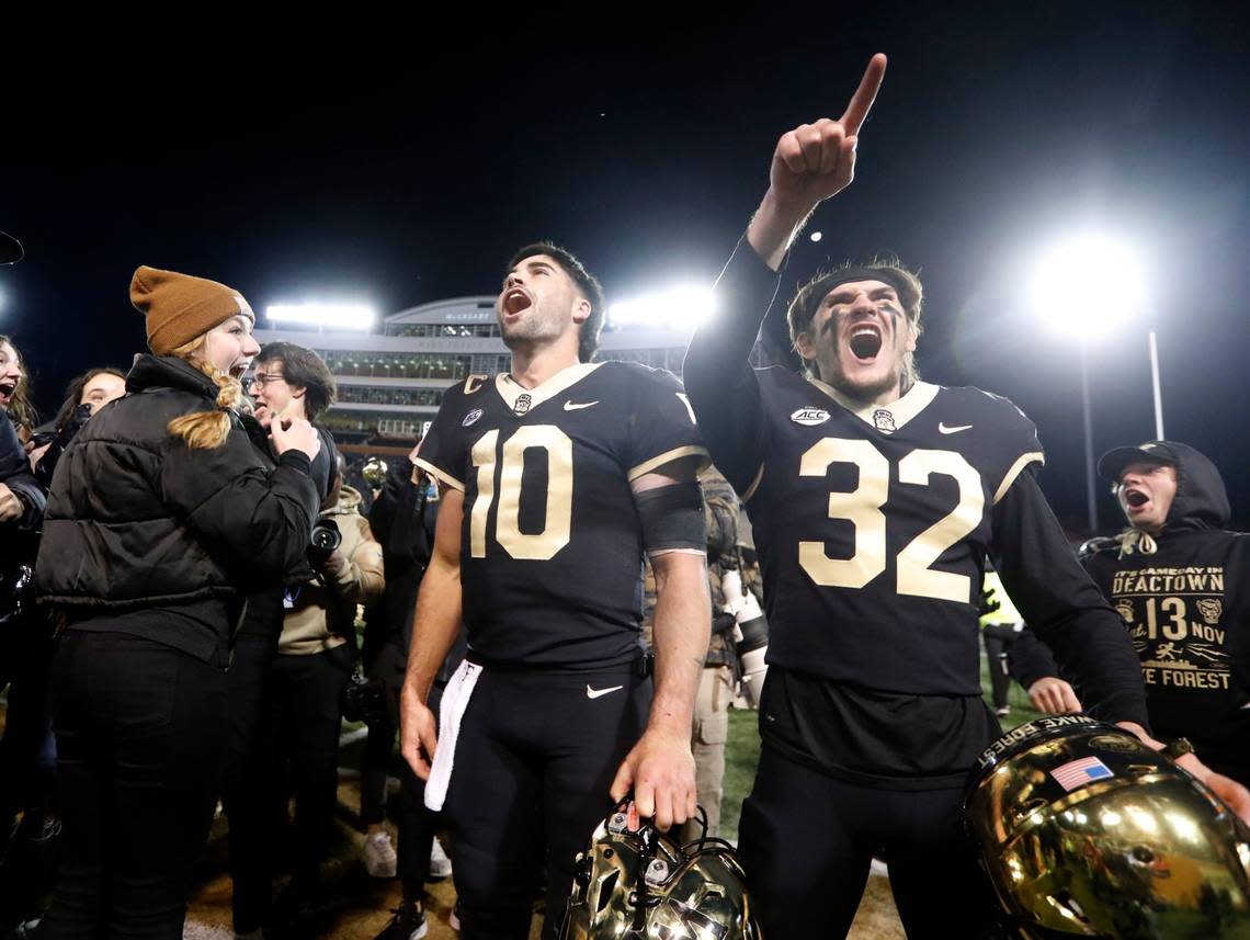 Wake Forest quarterback Sam Hartman (10) and wide receiver Jarrett Brown (32) celebrate after Wake Forest’s 45-42 victory over N.C. State at Truist Field in Winston-Salem, N.C., Saturday, November 13, 2021.