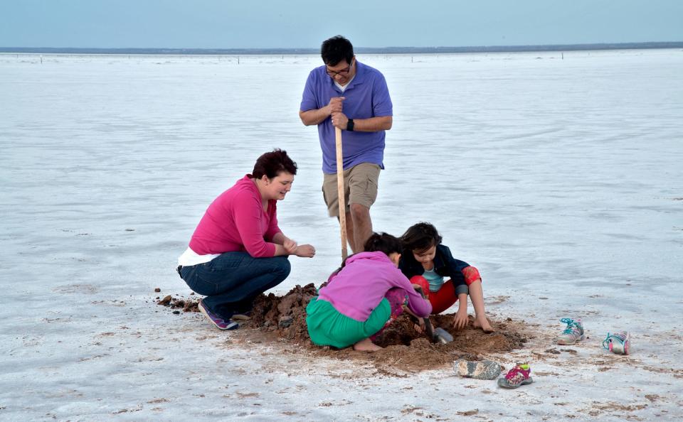 A family digs for crystals at the Salt Plains National Wildlife Refuge.