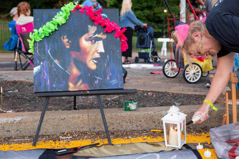 Donna Galloway lights a candle next to an Elvis memorial she and her husband Doug Galloway put together in front of Graceland prior to the start of the “Candlelight Vigil” as part of Elvis Week 2023 in Memphis, Tenn., on Tuesday, August 15, 2023. Galloway, who is a part of the Rock-a-Hoola Fan Club, said this is her seventeenth year in a row coming to the vigil and that they drove from Long Beach, Mississippi, to attend. “I’ve made so many friends. People that live here. People from other countries. You just never know,” she said. “This is our tribe. We’ve found our tribe.”