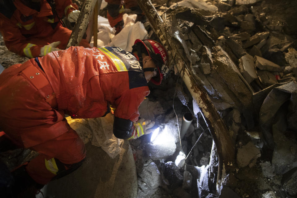 In this photo released by Xinhua News Agency, rescuers search for trapped victims at the site of a roof collapsed middle school gymnasium in Qiqihar, in northeast China's Heilongjiang Province on Monday, July 24, 2023. More than 10 people were killed when a roof collapsed at a middle school gymnasium in China's far northeast, authorities said Monday. (Zhang Tao/Xinhua via AP)