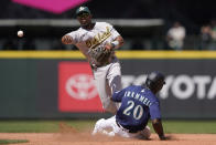 Seattle Mariners' Taylor Trammell (20) is forced out at second as Oakland Athletics' shortstop Elvis Andrus makes the throw to first to get Luis Torrens out for the double play during the fifth inning of a baseball game, Wednesday, May 25, 2022, in Seattle. (AP Photo/Ted S. Warren)