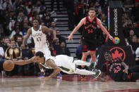 Milwaukee Bucks guard George Hill dives to claim a loose ball next to Toronto Raptors' Pascal Siakam (43) during the second half of an NBA basketball game Thursday, Dec. 2, 2021, in Toronto. (Chris Young/The Canadian Press via AP)