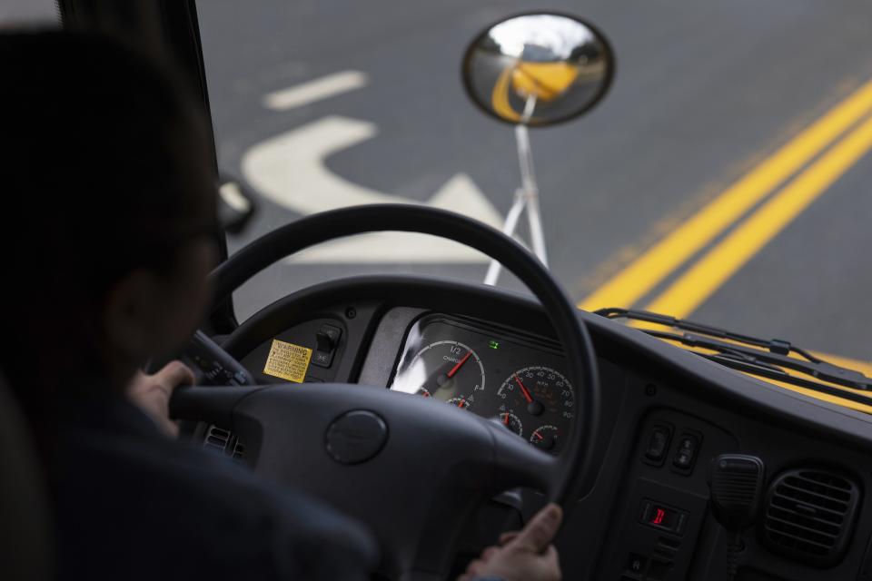 An electric school bus travels through Chevy Chase, Md., on Friday, Feb. 2, 2024. (AP Photo/Tom Brenner)