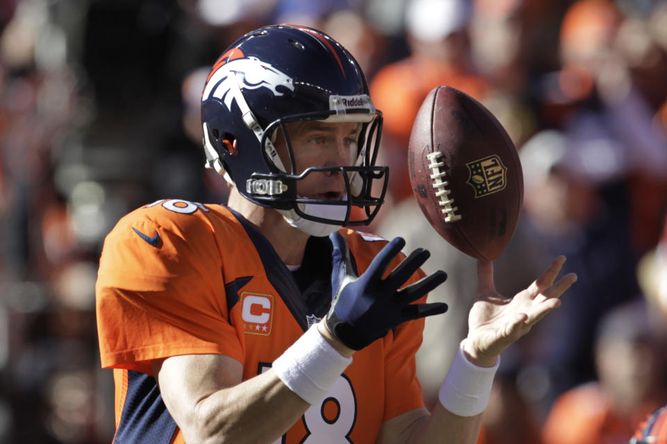 Denver Broncos quarterback Peyton Manning bobbles the ball on a bad snap during the first half of the AFC Championship NFL football game against the New England Patriots in Denver, Sunday, Jan. 19, 2014. (AP Photo/Joe Mahoney)