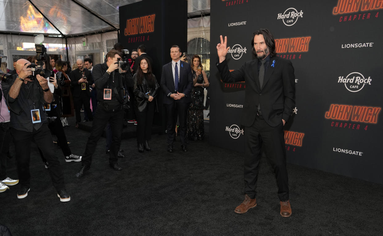 Keanu Reeves, right, star of "John Wick: Chapter 4," arrives at the premiere of the film, Monday, March 20, 2023, at the TCL Chinese Theatre in Los Angeles. (AP Photo/Chris Pizzello)