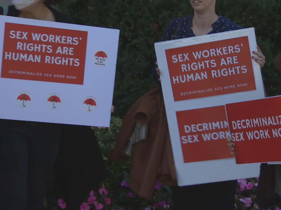 A group of protesters who gathered outside the Superior Court in Toronto on Monday as a landmark hearings on decriminalizing sex work got underway. (CBC - image credit)