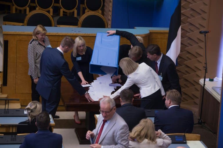 Estonian Parliament members empty  a ballot box after the last round vote of the presidential election, on August 30, 2016 in Tallinn