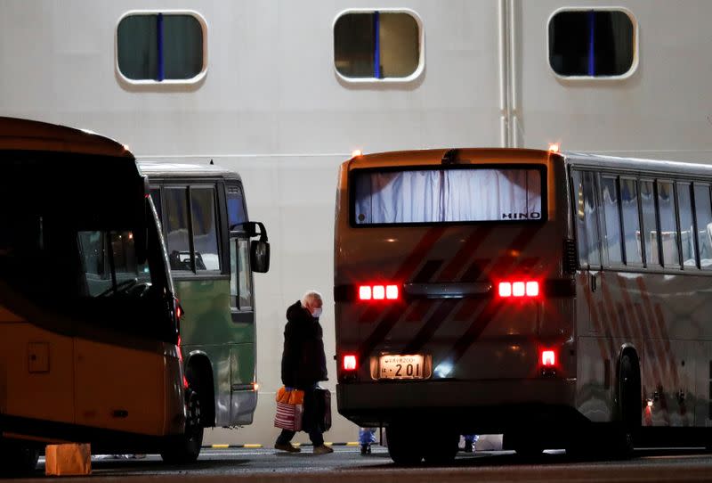 FILE PHOTO : Passengers leave cruise ship Diamond Princess at Daikoku Pier Cruise Terminal in Yokohama