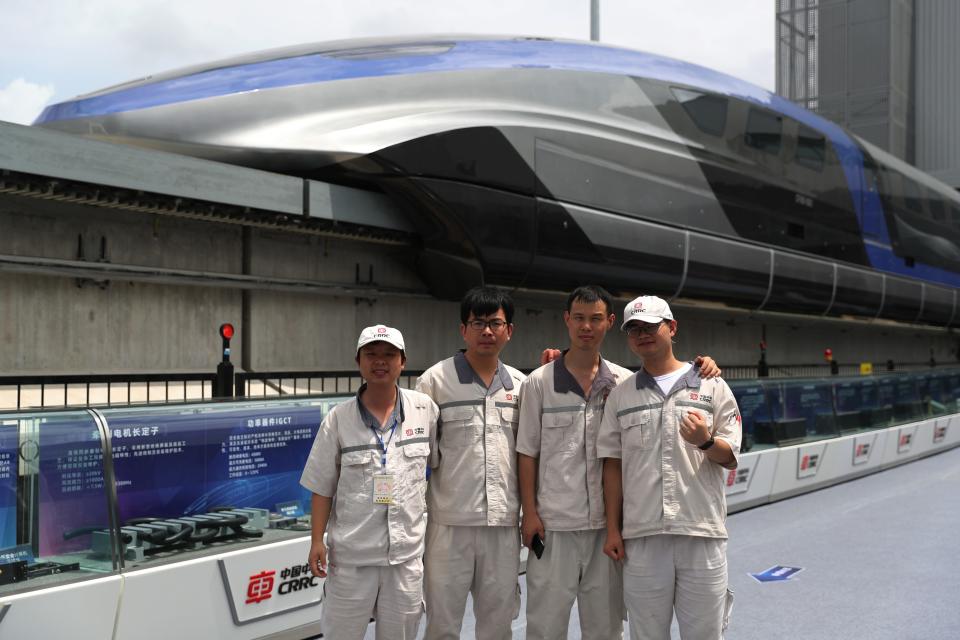 workers pose with train