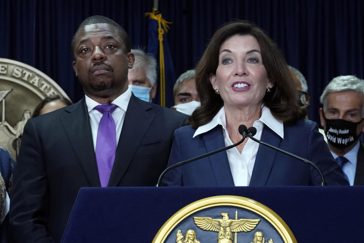 FILE — New York Gov. Kathy Hochul, accompanied by Lt. Gov. Brian Benjamin, left, speaks during ceremonies in the governor's office, in New York, Sept. 17, 2021. Benjamin, whose seven months in that role has been overshadowed by probes into a previous campaign, was arrested Tuesday, April 12, 2022 in a federal corruption investigation. (AP Photo/Richard Drew, File)