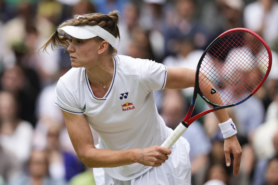 Elena Rybakina of Kazakhstan serves to Elina Svitolina of Ukraine during their quarterfinal match at the Wimbledon tennis championships in London, Wednesday, July 10, 2024. (AP Photo/Kirsty Wigglesworth)