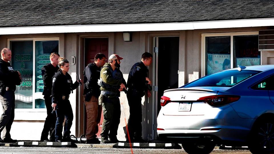 Kennewick police help federal agents search a massage business at 6201 West Clearwater Ave. in March 2023.